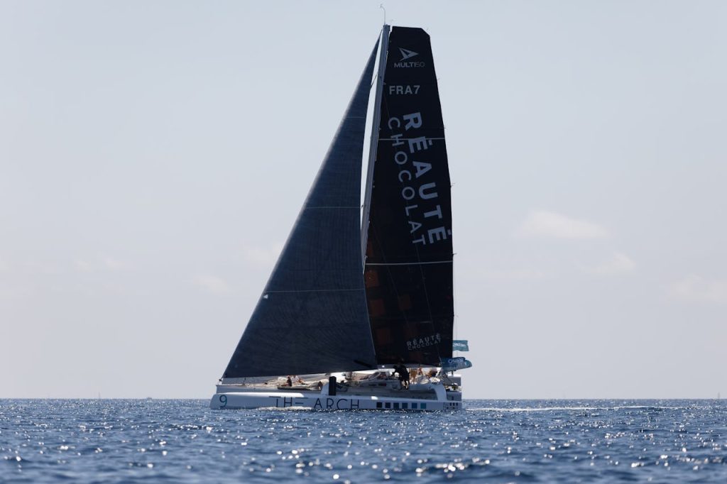 pexels photo 9028273 A sleek sailing yacht glides over calm ocean waves under a clear blue sky, capturing serene maritime beauty.